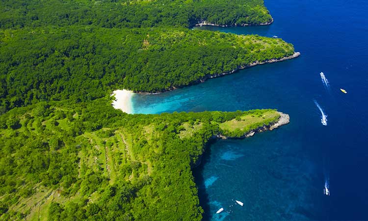 Nusa Penida, island in indonesia from above, trees and boats and sea, Bali