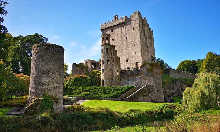 Blarney Castle, before blue sky and green landscape, big tower