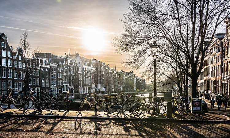 Sonnenaufgang in Amsterdam, Fahrräder vor Kanal