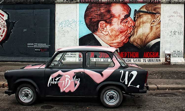 The kiss graffiti on Berlin wall with trabi